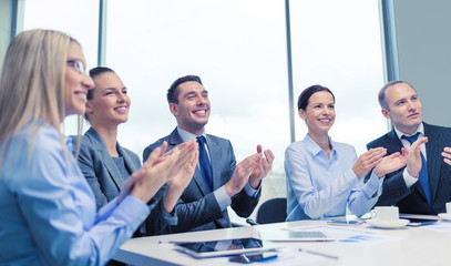 business team with laptop clapping hands