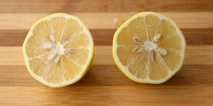 Two lemon slices on wooden background