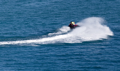 Obraz premium jet ski on the surface of the water at a speed of