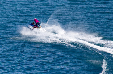 Obraz premium jet ski on the surface of the water at a speed of