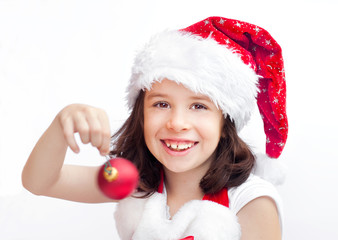 Child wearing Santa Claus hat with a Christmas ball