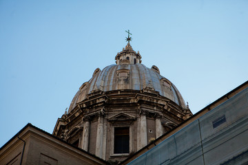 Fototapeta na wymiar Dome of old Italian cathedral raises to the blue sky