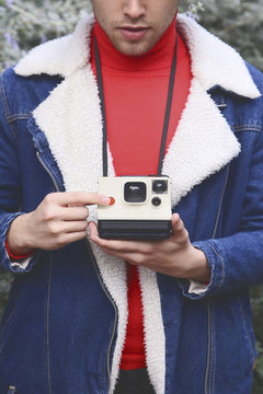 Man taking instant photography outdoors