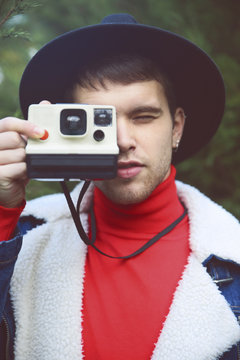 Man taking instant photography outdoors