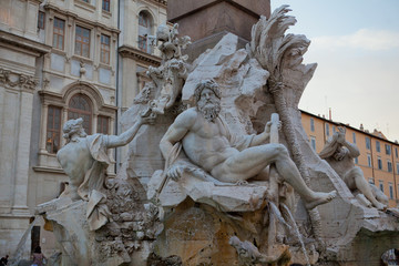 Figures of Roman gods lying around on the fountain
