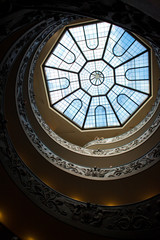 Look from below at spiral stairs leading to glass roof