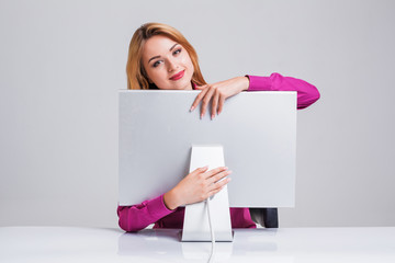 young woman sitting in the table and using computer