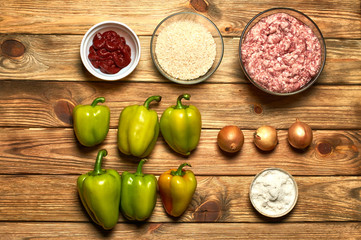 Pepper, beef, rice, tomato paste, salt, onion on a kitchen table. The process of preparing the main dishes.