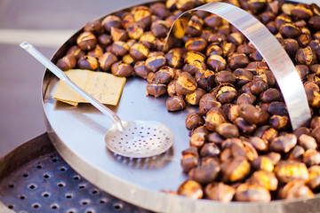 Roasted chestnut lies on steel dish
