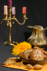 Typical Dutch filled spicy  cookies with almonds on autumn colors on black