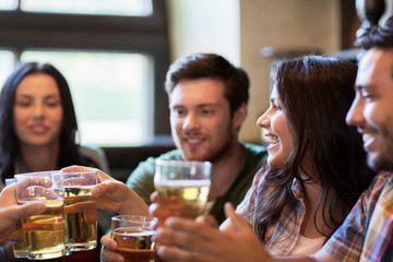 happy friends drinking beer at bar or pub