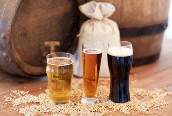 close up of beer barrel, glasses and bag with malt