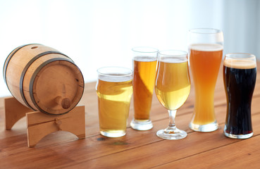 close up of different beers in glasses on table