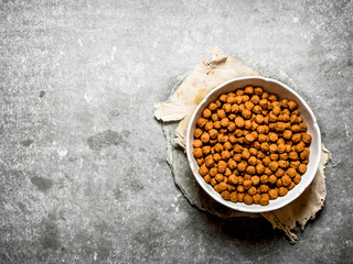 Chocolate cereal in a Cup on the old fabric.