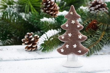 Fototapeta na wymiar gingerbread Christmas tree on the background of branches