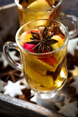 hot apple tea with spices and gingerbread cookies, closeup 