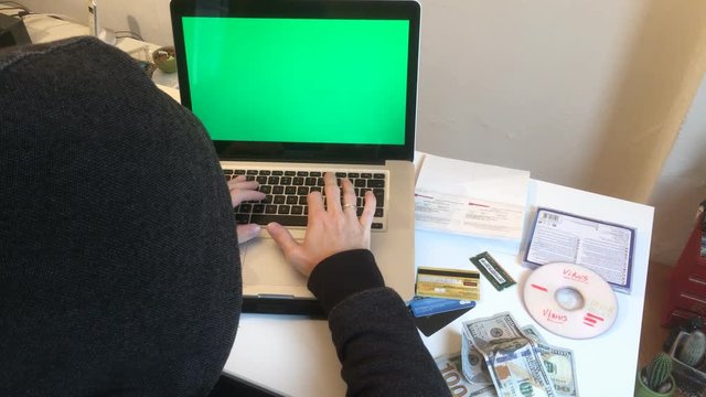 Computer Hacker Programming Green Screen Laptop. A hacker is a highly skilled computer expert. Someone who seeks and exploits weaknesses in a computer system or computer network