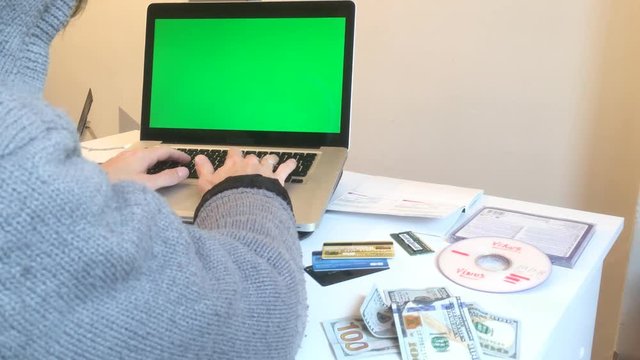 Hacker Cyber Crime Attack On Computer, Green Screen. A hacker is a highly skilled computer expert. Someone who seeks and exploits weaknesses in a computer system or computer network