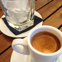 'Cafe solo con hielo'.  expresso coffee served with a glass of ice. The coffee is poured over the...