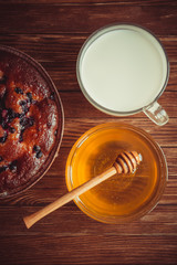 Fruit cake, honey and milk.