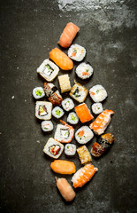 Different sushi and rolls with seafood.