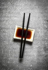 Soy sauce with chopsticks for sushi.