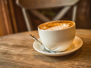 Cup of coffee on the wooden table. Concept on a theme of vivacity, energy, tasty breakfas