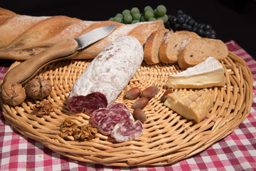 top view of glass of red wine and various cheeses. close up