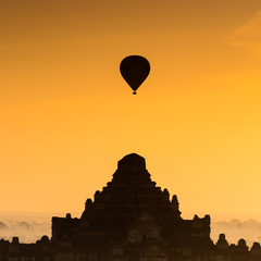Fototapeta na wymiar Silhouette pagoda on sunrise time in morning and balloon at Baga