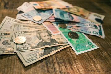 Variable banknotes on wooden table, currency exchange