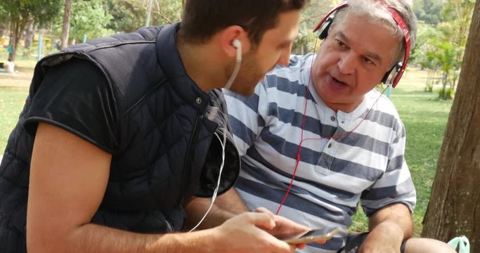 Friends of Different Generations Using Technology in a Park