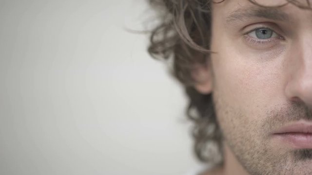 Half side of young men face looking at camera