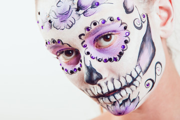 Girl with Halloween face art on white background