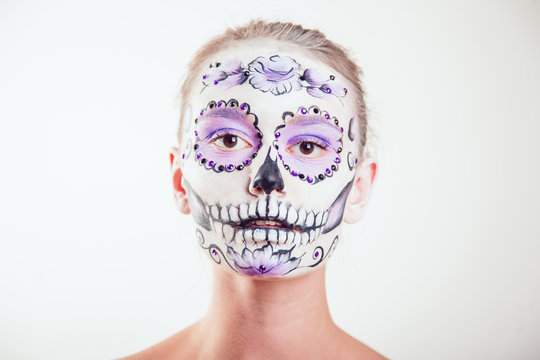 Girl with Halloween face art on white background