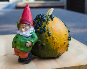 Little funny gnome sculpture thinking what to do