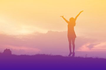 Fototapeta na wymiar silhouette of woman happy jumping at sunset