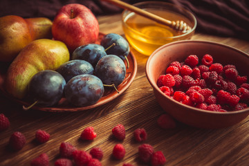 The new crop of fruit and honey on the table.