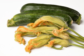 Zucchini and organic flowers on a white background