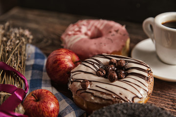 Donuts and coffee on wooden table