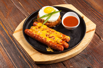 sausages in a pan with cheese