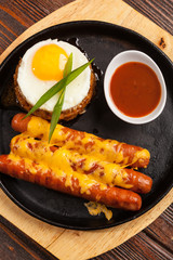 sausages in a pan with cheese
