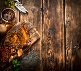 Pork ribs grilled with a meat hatchet and beer.