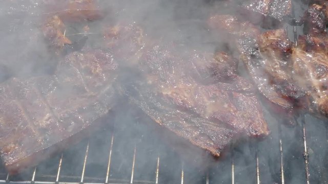 Close up of Pork Meat Steak on Barbecue Grill