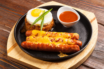 sausages in a pan with cheese