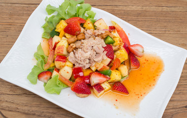 Thai style spicy salad on wood table.