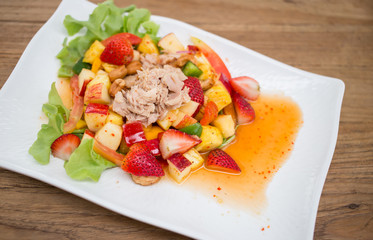 Thai style spicy salad on wood table.
