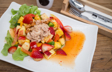 Thai style spicy salad on wood table.