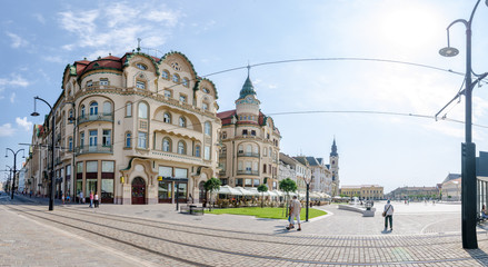 10 September 2016 - Oradea, Romania: Black Eagle Complex Palace ( Vulturul Negru ) in the Unirii Square of the city built in secession style and the tram lines running in front on the pedestrian area