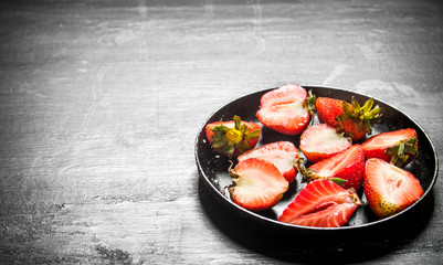 Halves of strawberry in the old plate.