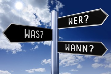 Signpost with three arrows - who?, what?, when? (English)/ wer? was? wann? (German).